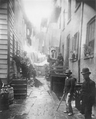 Photograph by Jacob Riis. Bandit's Roost, 1888, from How the Other Half Lives.