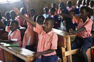 Photograph of student raising his hand.