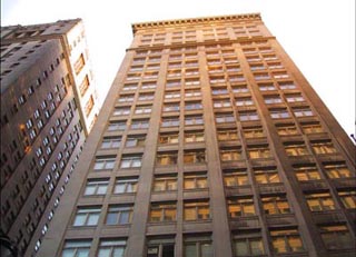 Photograph of a building facade in the sunlight.