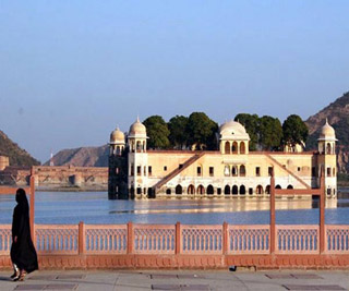 Photo of large palace surrounded by a body of water.