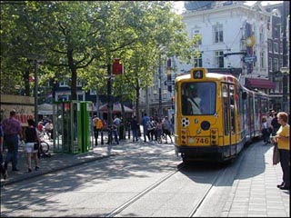 A photo of a street scene with a street car.